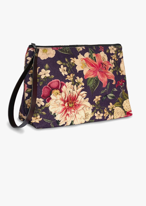 Toiletry case with regenerated leather handle with floral design on aubergine background