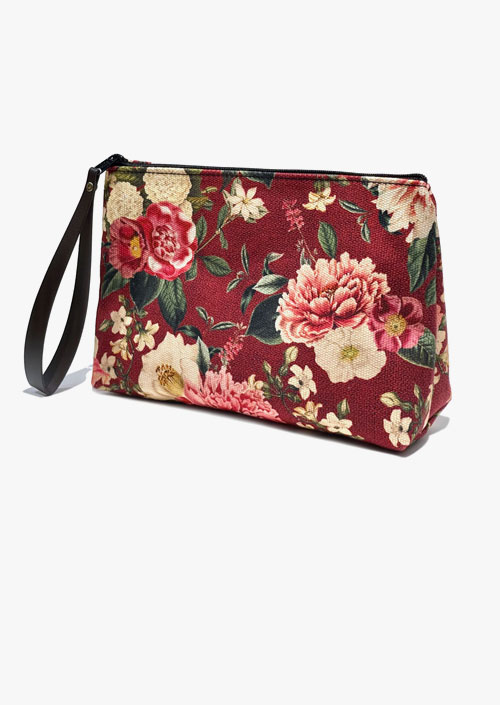 Toiletry bag with floral design on a maroon background